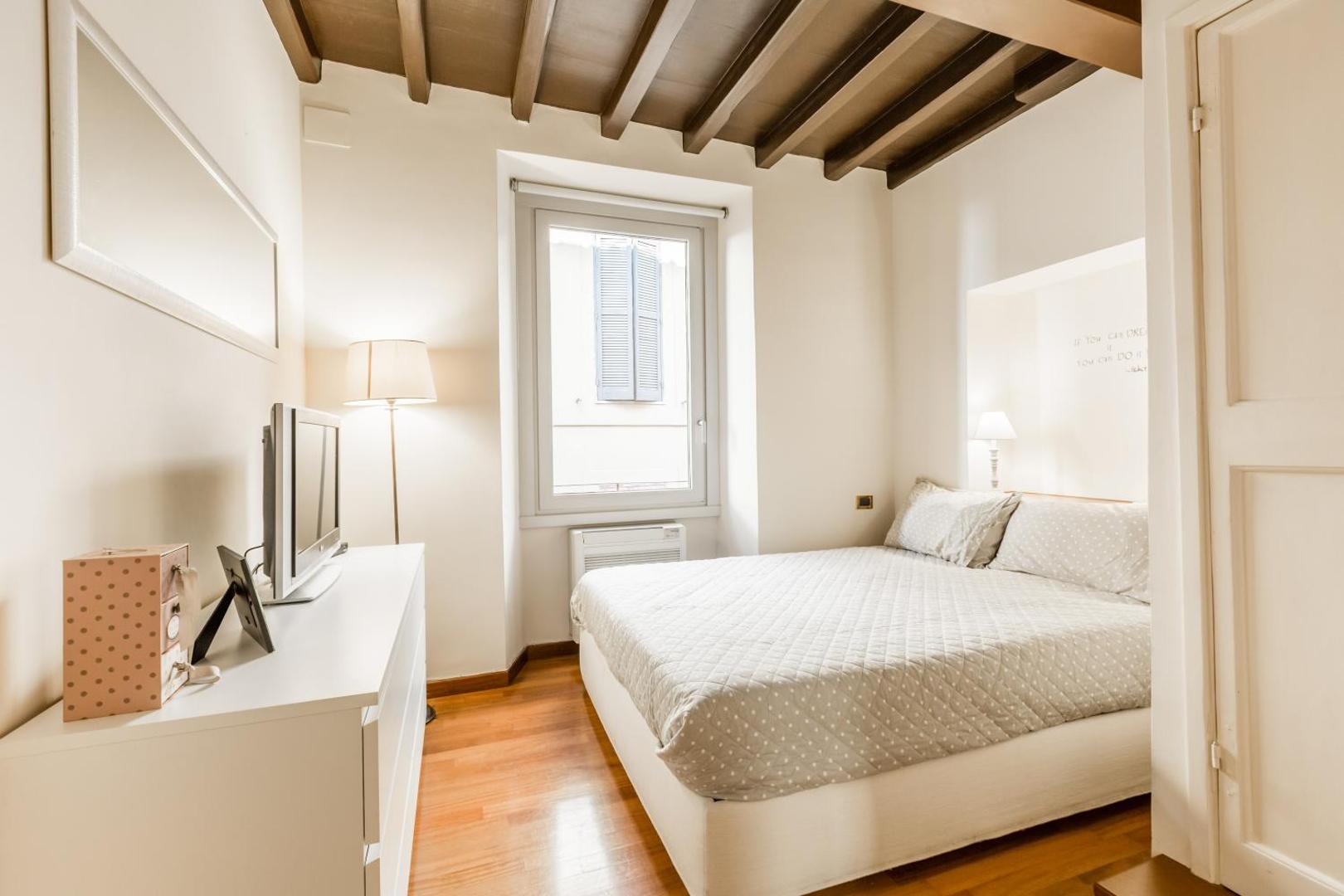 The bedroom, with the large double bed and a window onto the street