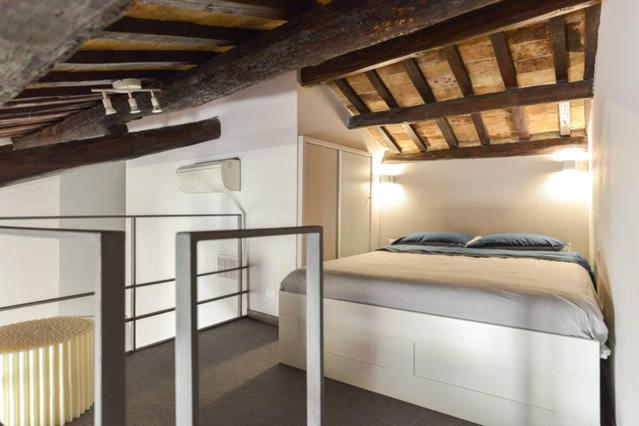 The mezzanine bedroom, tucked under the original beams