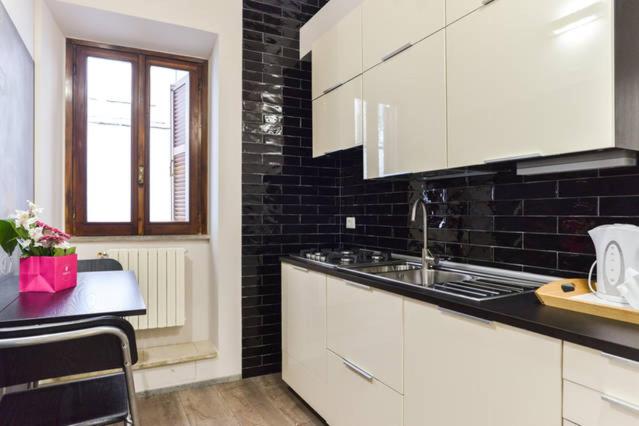 The kitchen, with dark tiling and a window