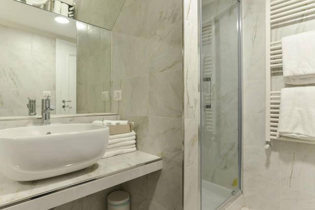 The marble bathroom, with walk-in shower and heated towel rail